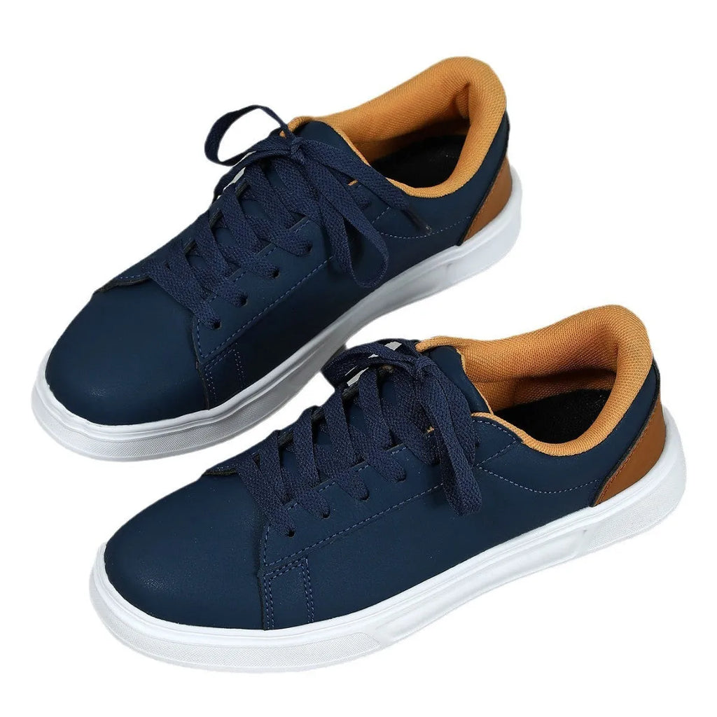 Beige brown platform skateboard sneaker with low top, round toe, and cross-belt design on a white background.