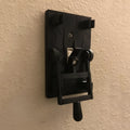 Retro-style mechanical light switch with a decorated plate for exposed wall installation.