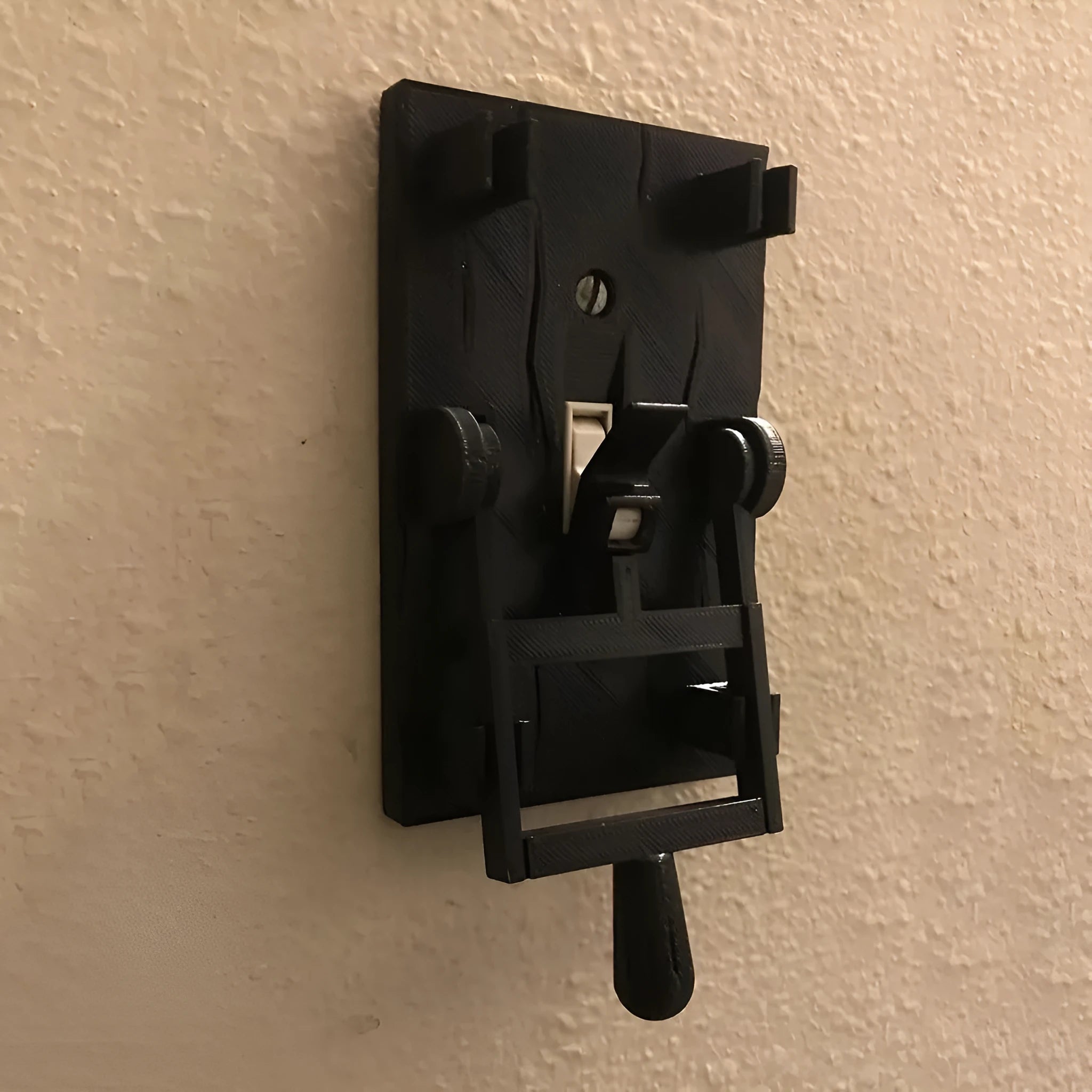 Retro-style mechanical light switch with a decorated plate for exposed wall installation.