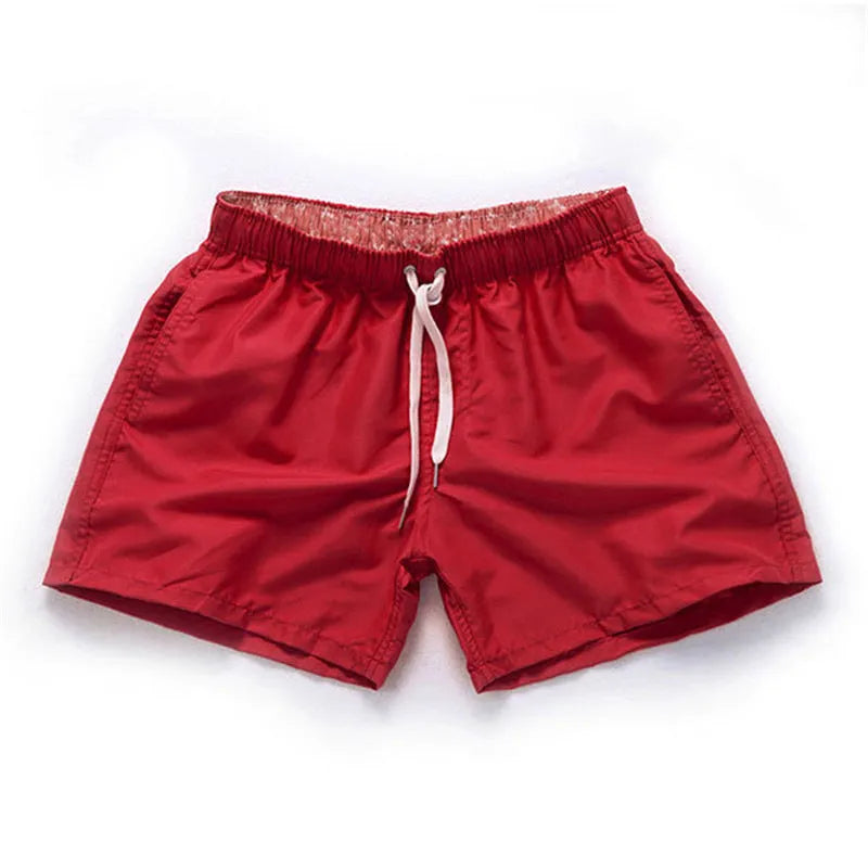Men's polyester beach shorts with straight leg opening in multiple colours including black, white, and fluorescent yellow