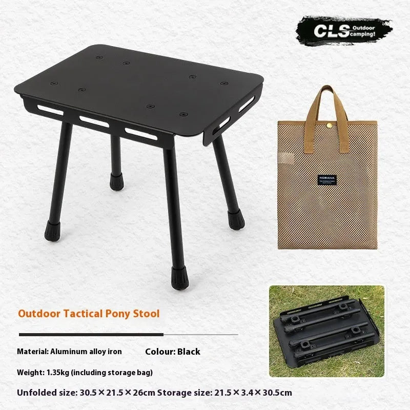 Aluminium folding camping stool that converts into a small table, shown with a tactical storage bag and a beige PU cushion.