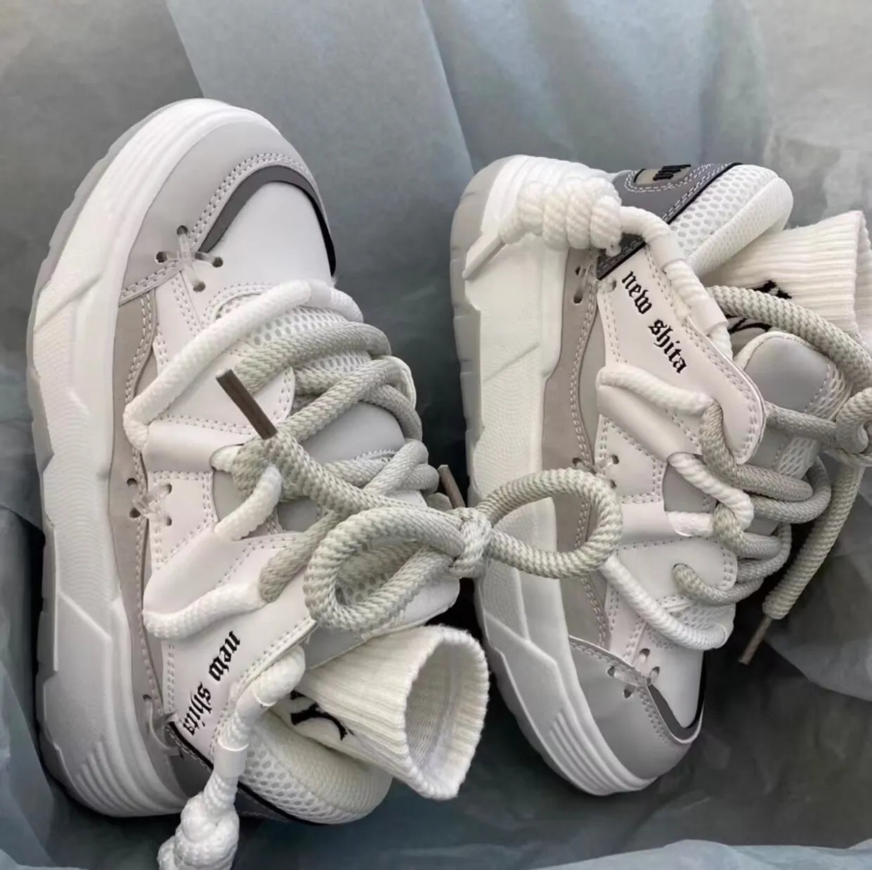 Women's grey retro chunky high-top sneakers with thick rubber platform sole and lace-up front.