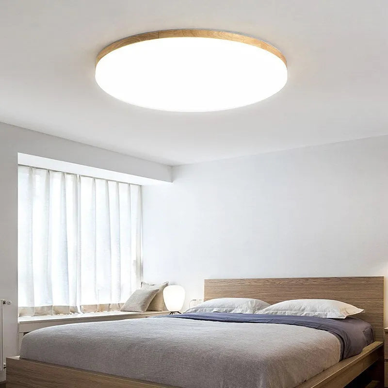 Japanese minimalist style ceiling lamp with a natural wood art body and a white acrylic diffuser shade.