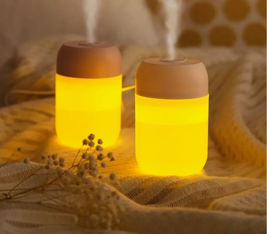 White cylindrical USB-powered mini humidifier with aromatherapy function on wooden desk