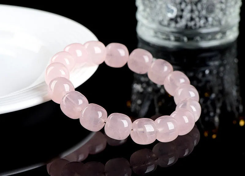 Pink bamboo crystal barrel bead bracelet with 11-12mm geometric beads on wrist