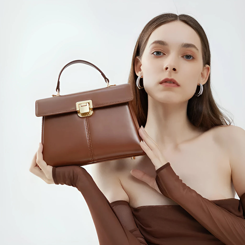 Women's black genuine leather shoulder bag with vachette clasp closure showing horizontal square design