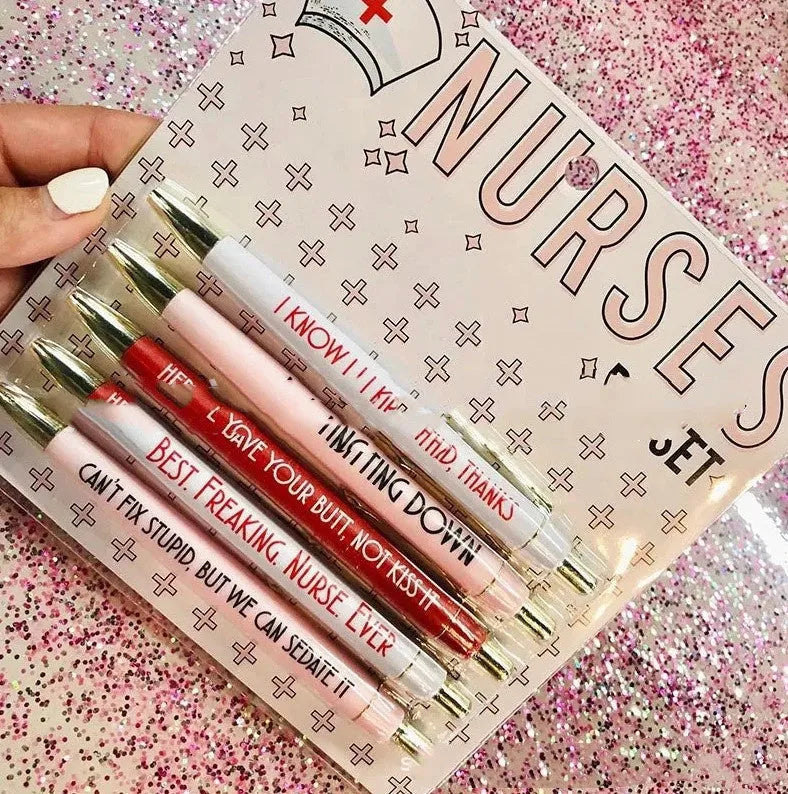 Five nurse-themed retractable ballpoint pens laid out, showing humorous medical designs.