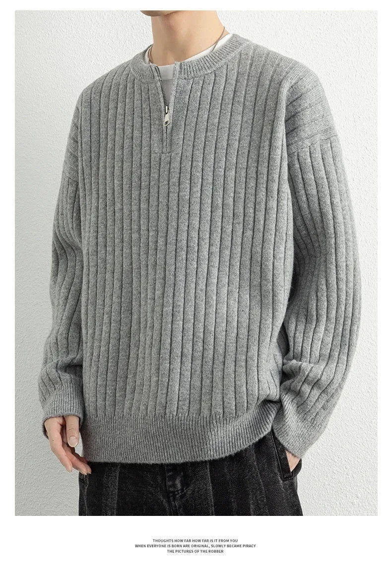Men's grey loose fit half-zip pullover sweater with textured knit and long sleeves.