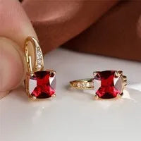 Square geometric ear hook earrings with zircon stones in an electroplated copper setting.