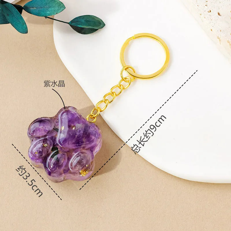 Natural crystal cat's paw keychain pendant in various gemstone colours including pink, red, blue, and green