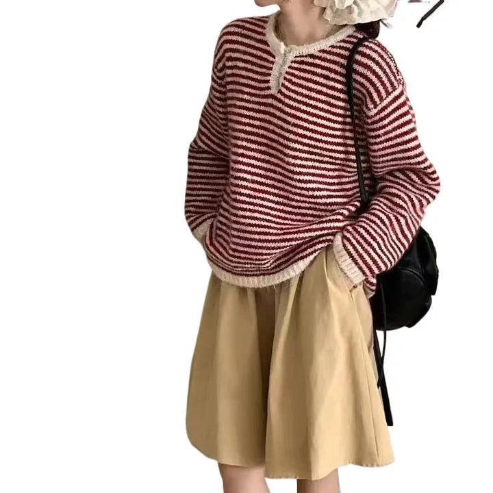 Red and blue striped women's cashmere pullover sweater on a hanger.