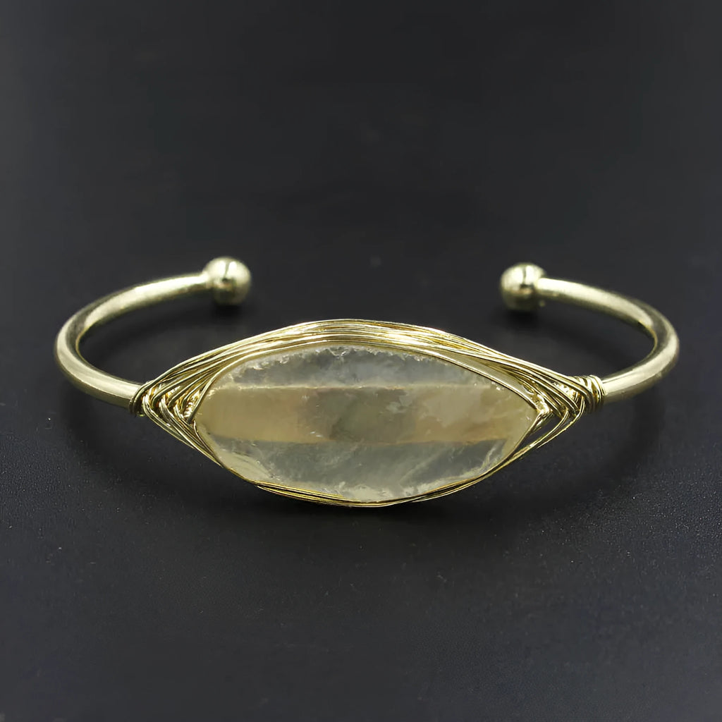 Raw gemstone winding bracelet with 8mm amorphous crystal beads in various colours on a white background.