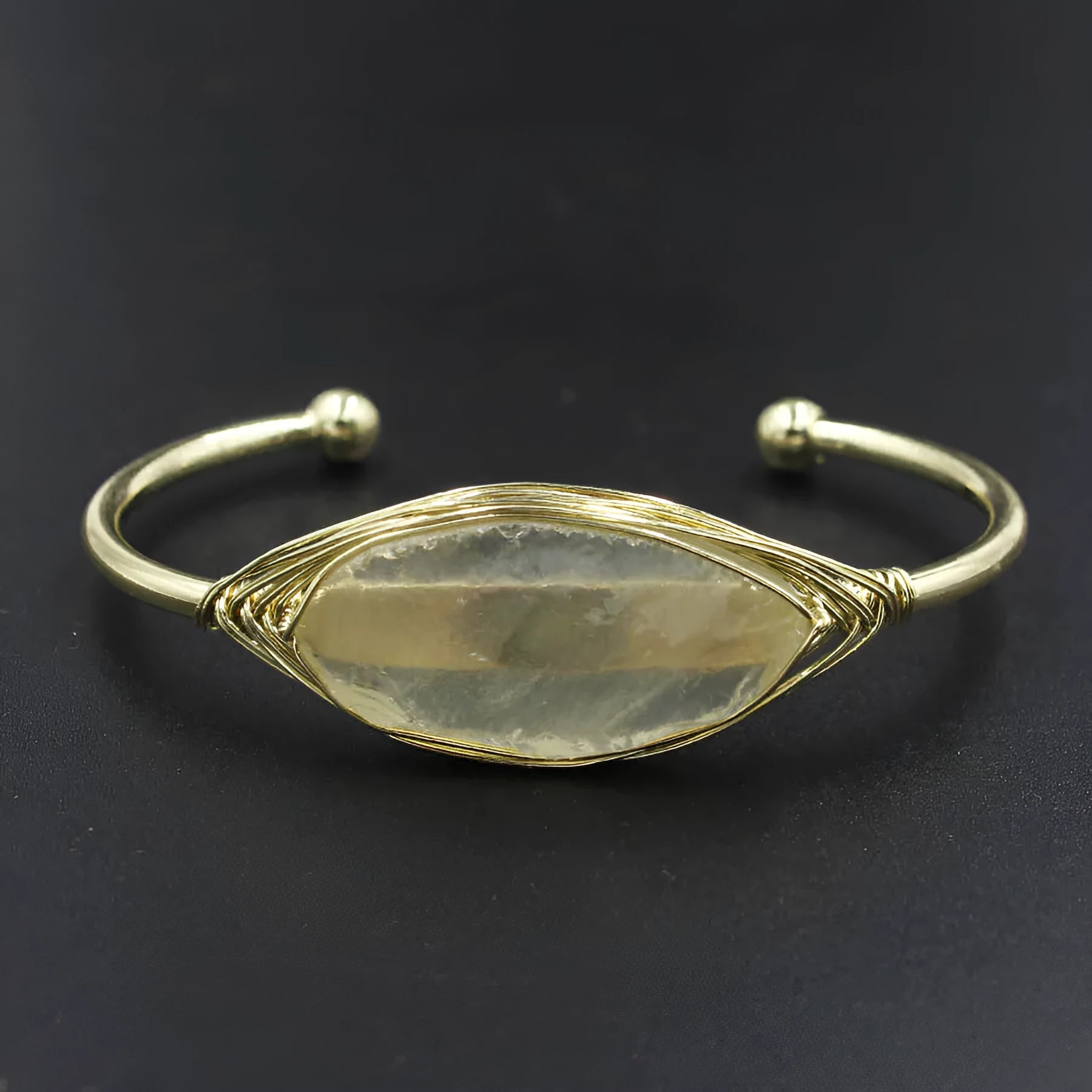 Raw gemstone winding bracelet with 8mm amorphous crystal beads in various colours on a white background.