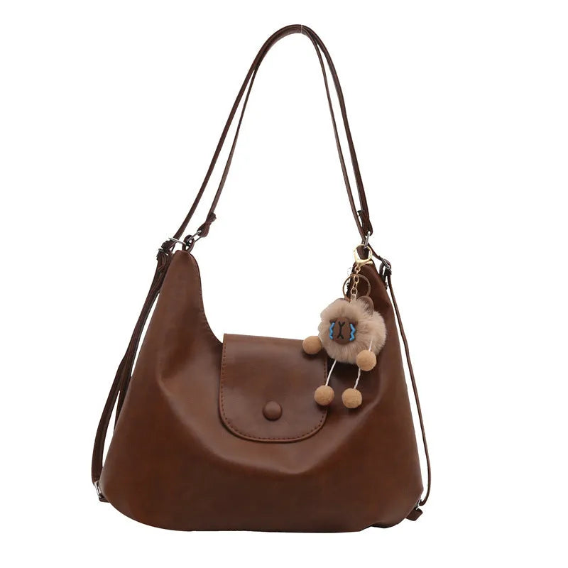 Women's textured PU leather shoulder bag with single strap and mobile phone compartment in black colour