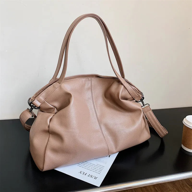 Soft surface messenger bag with adjustable strap showing mobile phone pocket and zipper compartments