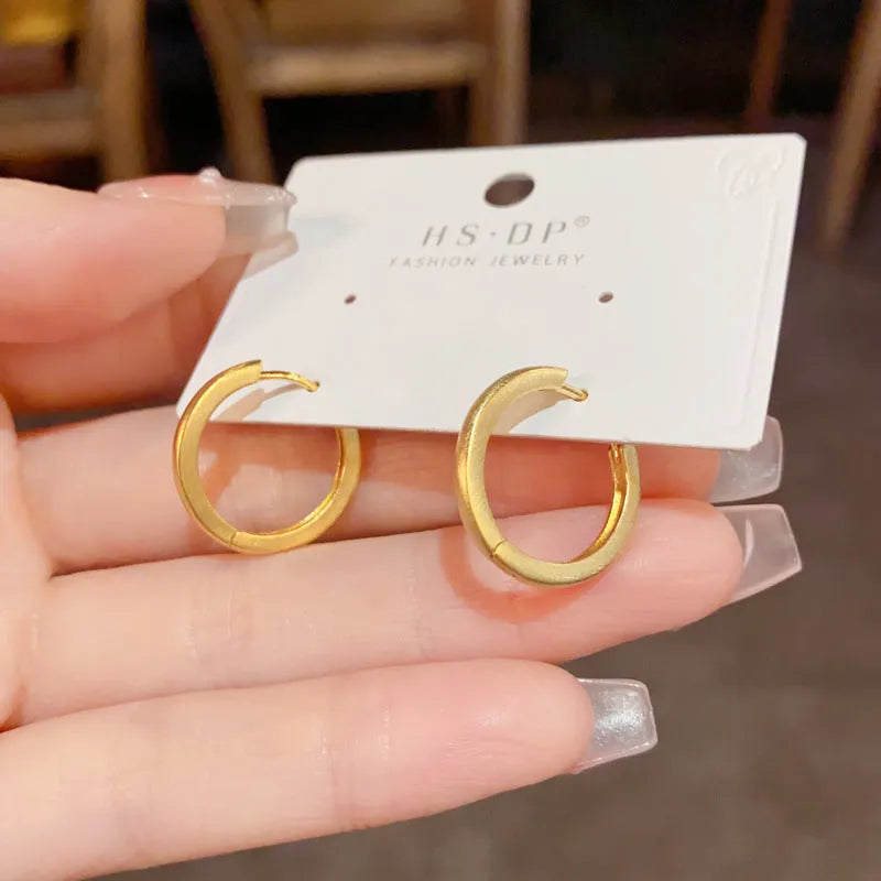 Geometric gold or silver-plated ear clip with round eyelet detail for women