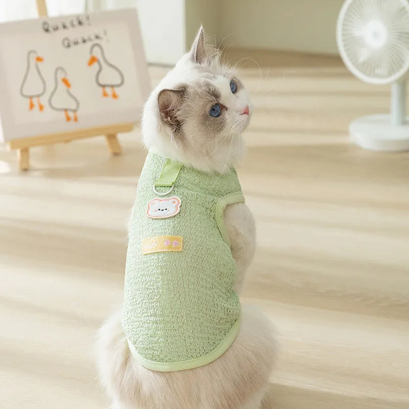 Green knitted cat clothes with bear patch showing hollowed-out breathable design