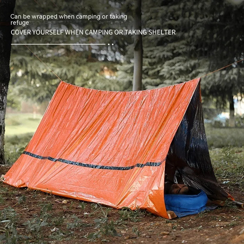 Orange emergency survival tent with sleeping bag and blanket for disaster relief