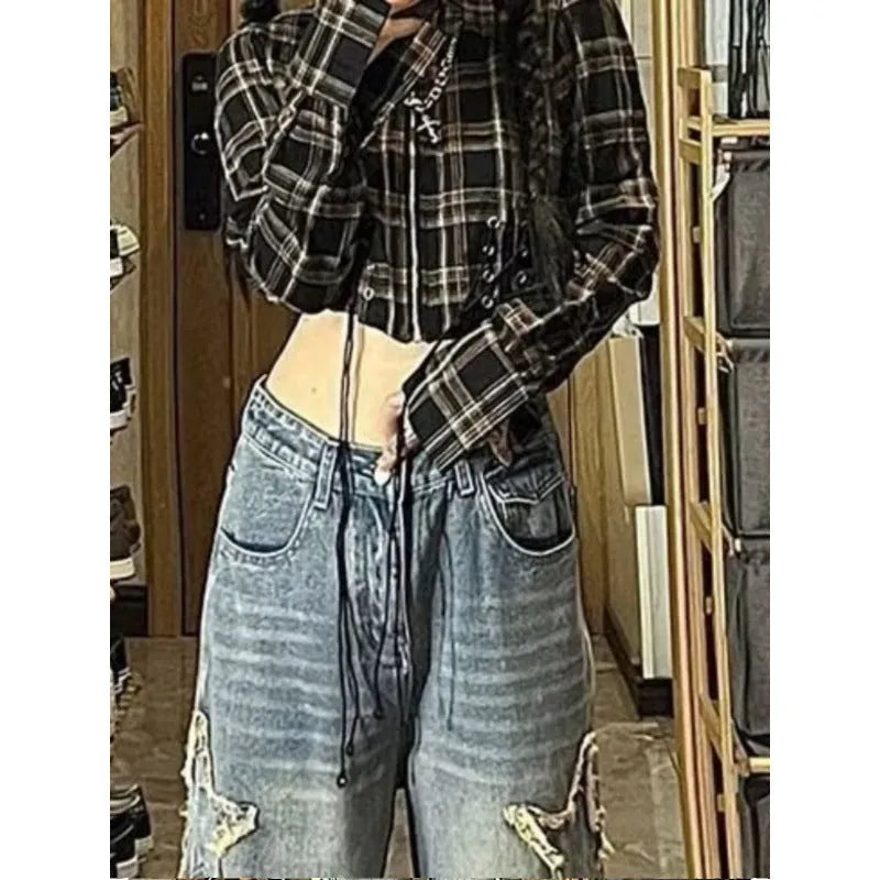 Blue high-waisted women's wide-leg denim trousers laid flat, showing straight-leg cut and front details.