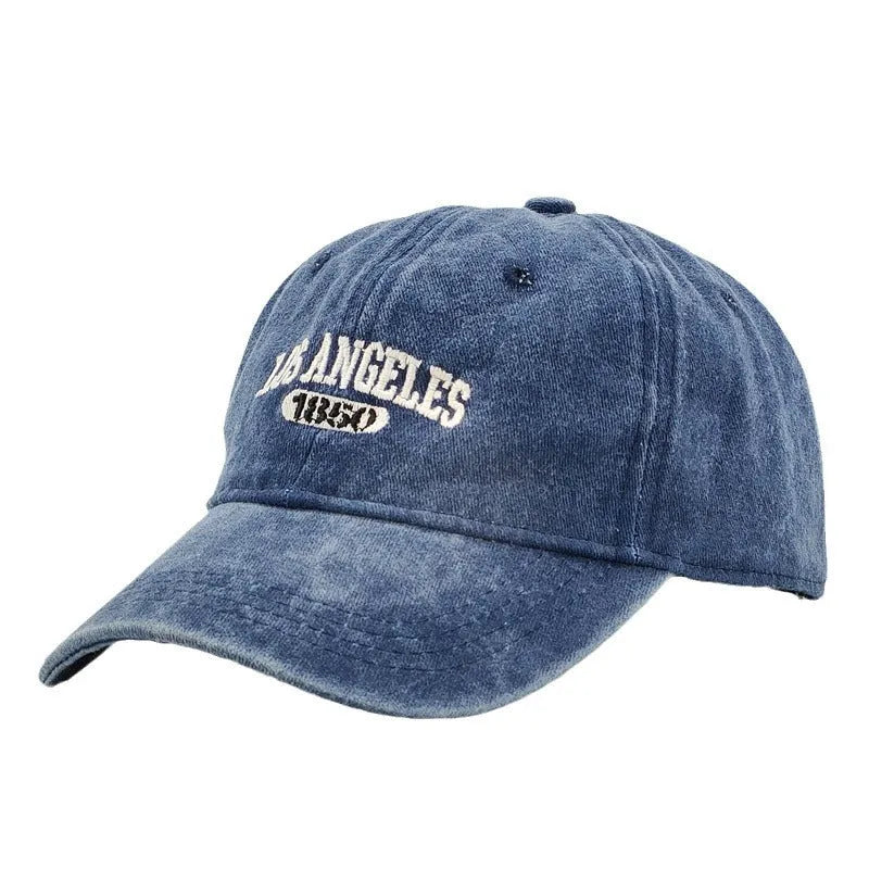 Retro peaked cap with distressed letter embroidery and adjustable sizing in conical crown design
