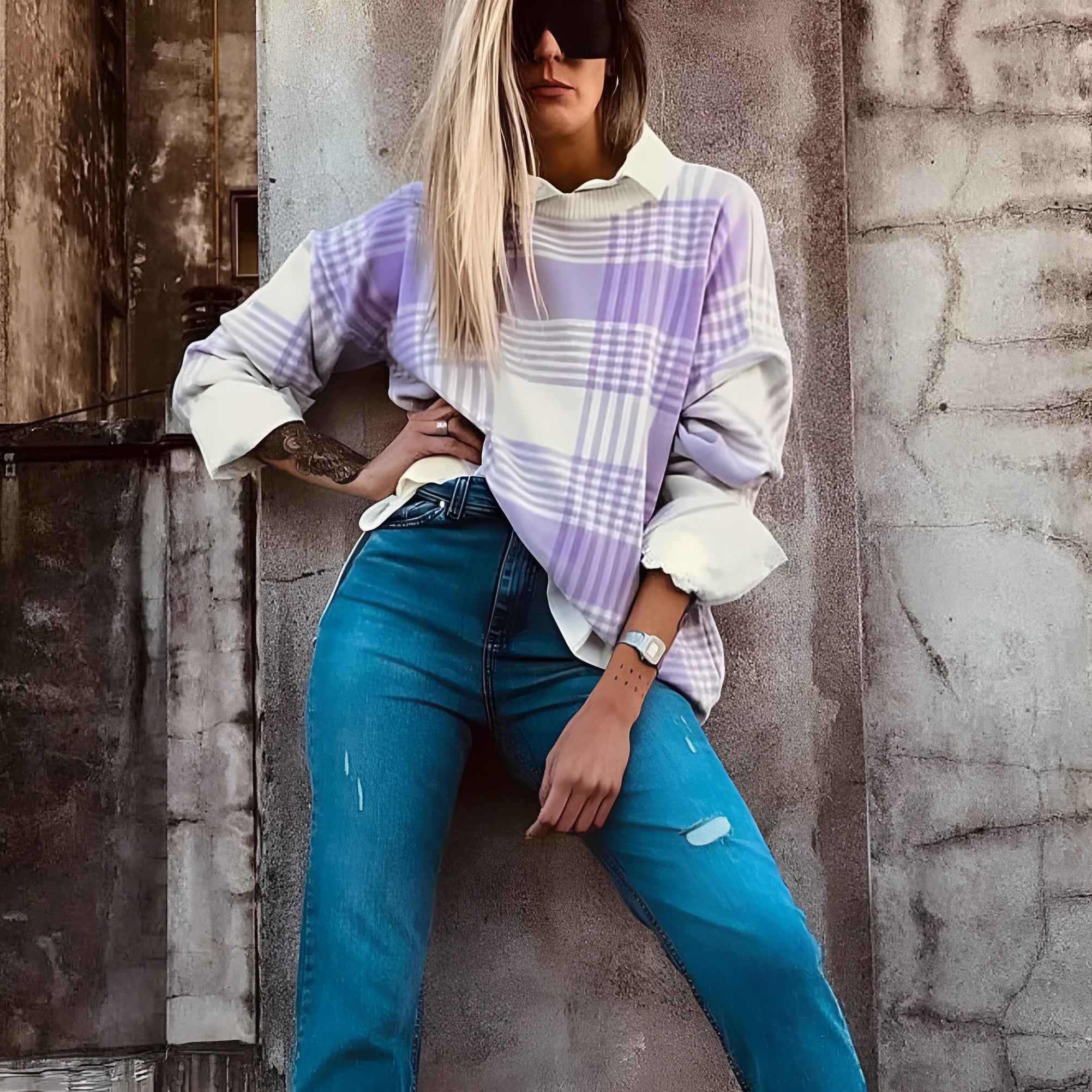 Lilac plaid print loose fit long sleeve sweater with ribbed cuffs on a hanger.