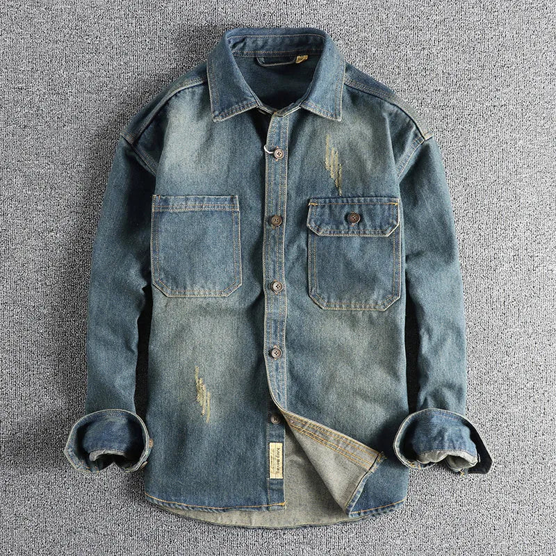 Men's light blue washed vintage denim shirt with long sleeves and a loose cardigan fit.