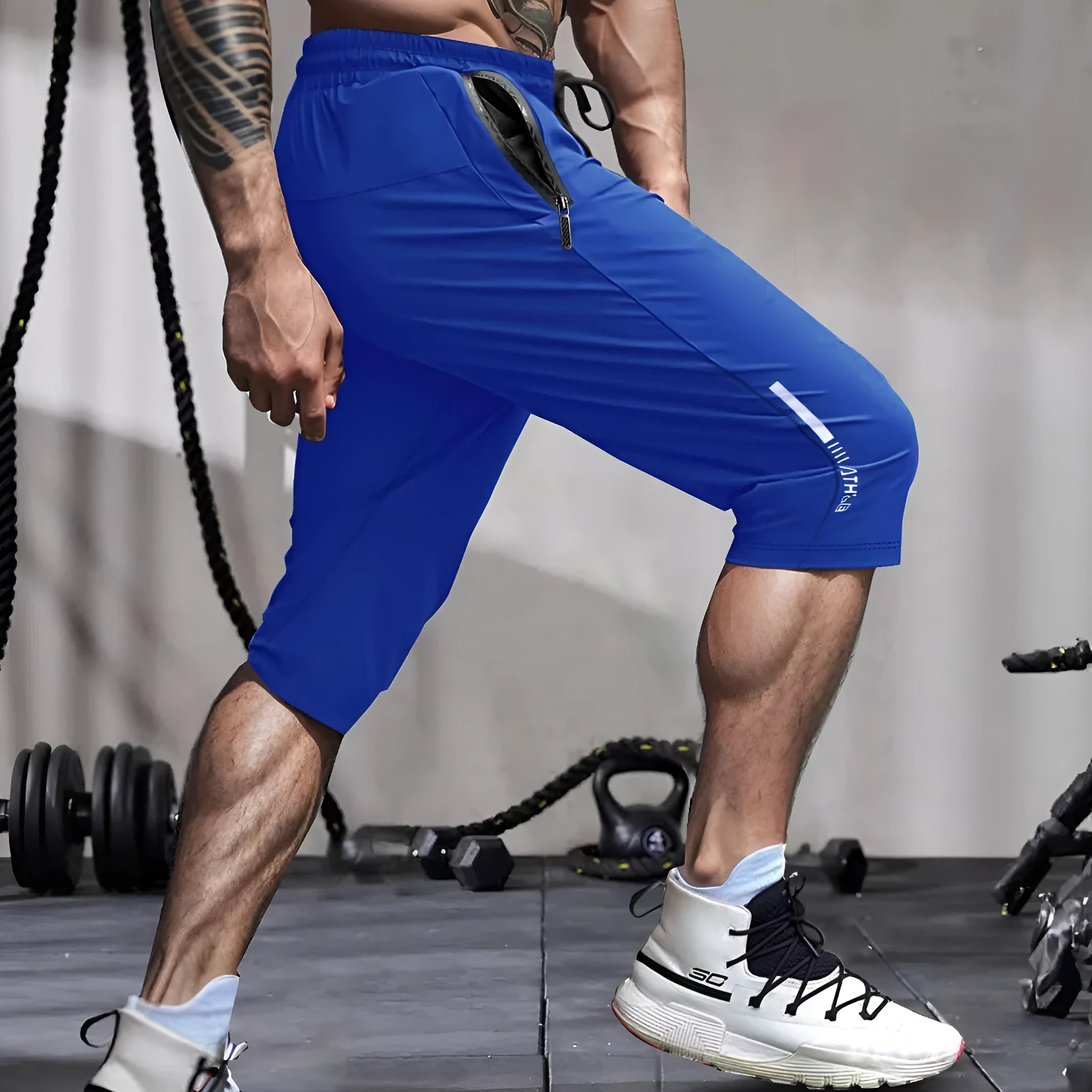 Man wearing grey cropped straight-leg casual sports pants made from quick-dry nylon fabric.