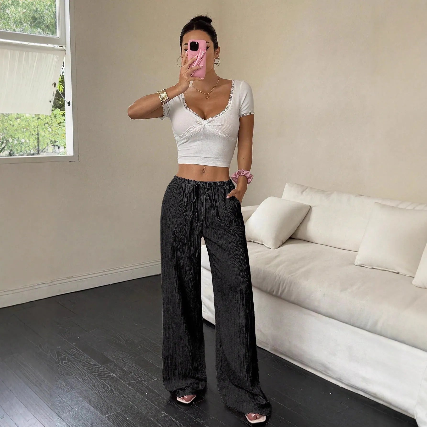 Women's black wide leg trousers with lace-up waist detail, shown with pink colour option