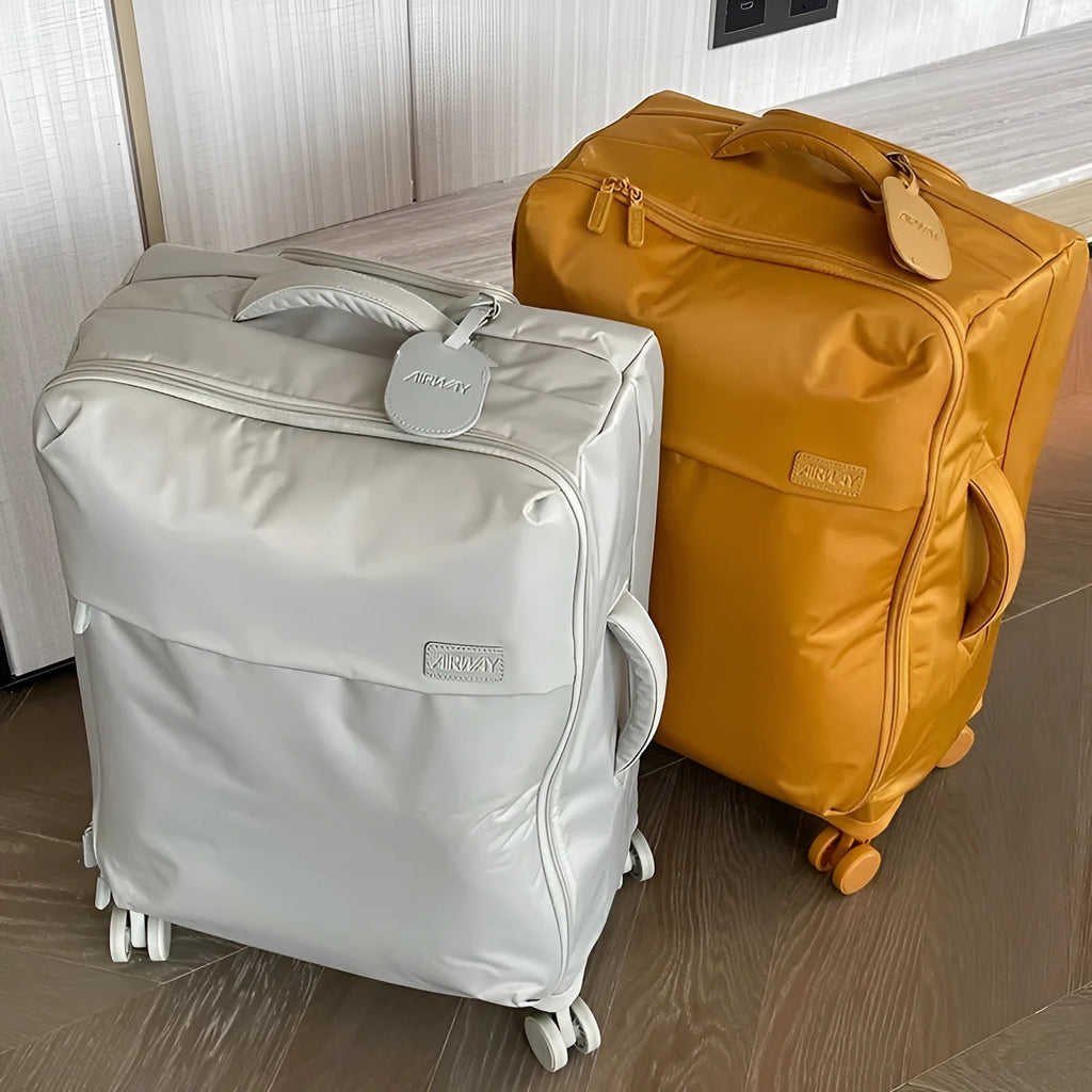 Ultra-light waterproof Oxford cloth suitcase with universal wheels in a bluestone green colour.