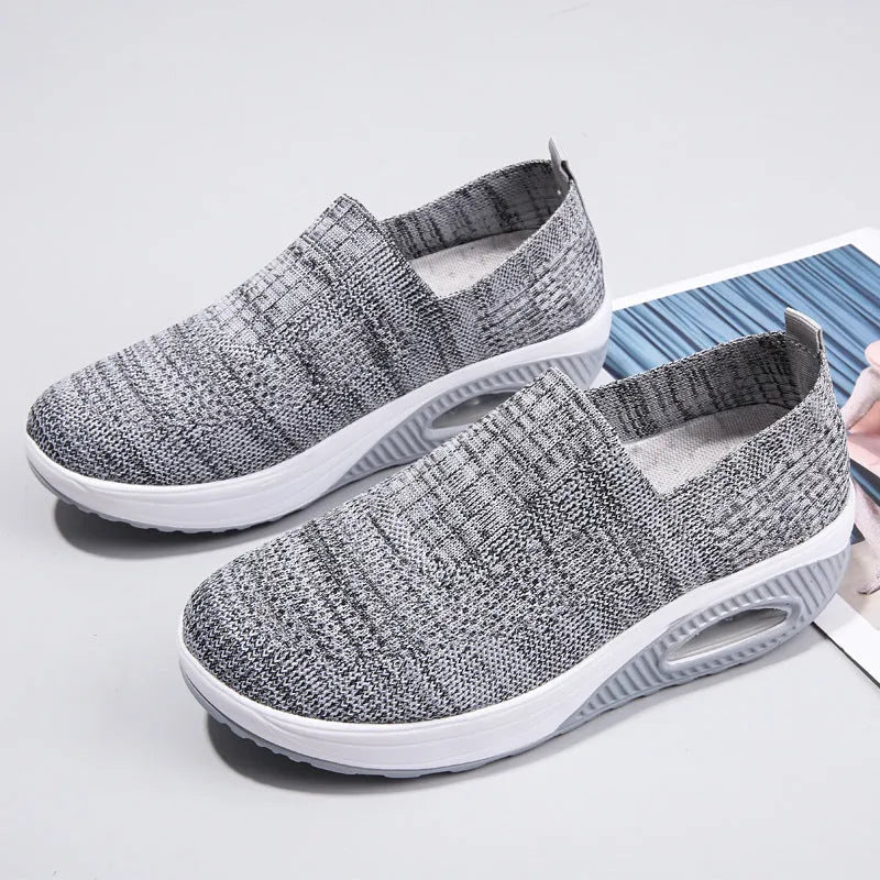 Women's mesh running shoes with air cushion midsole in beige colour on a white background.