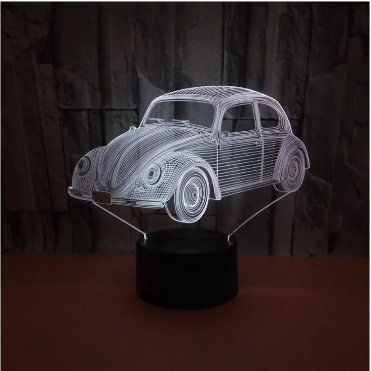 Small 3D LED table lamp with colourful acrylic shade and remote control on wooden desk