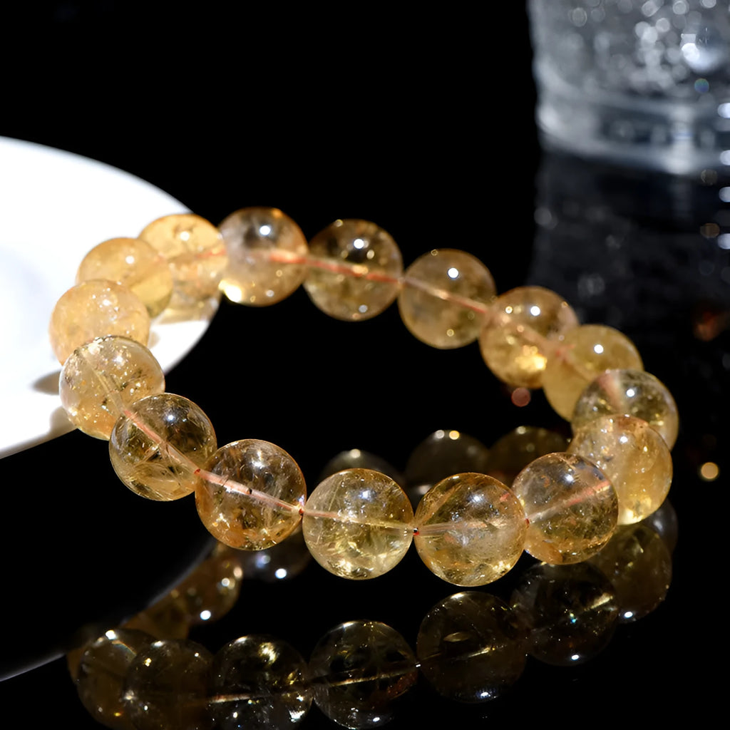 Natural yellow citrine gemstone bead bracelet showing geometrical beads on a string.