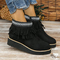 Women's black suede wedge ankle boots with side zip, tassel, and thick rubber sole.