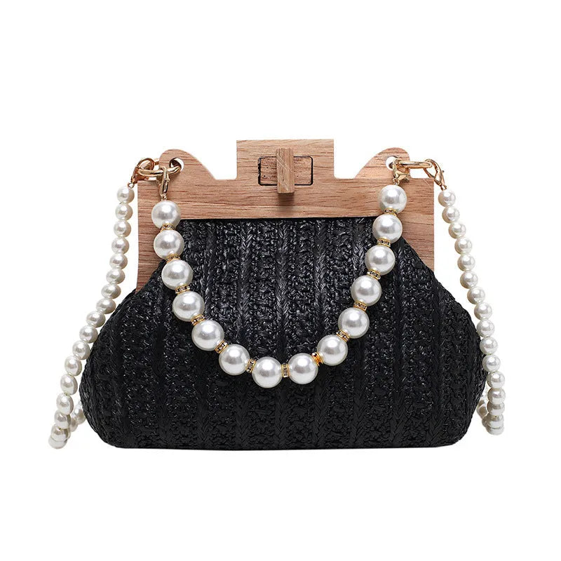 Women's straw woven shoulder bag with pearl chain detail showing internal organisation compartments