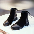 Black women's knee-high Martin boots with a bow detail and side zip on a rubber sole.