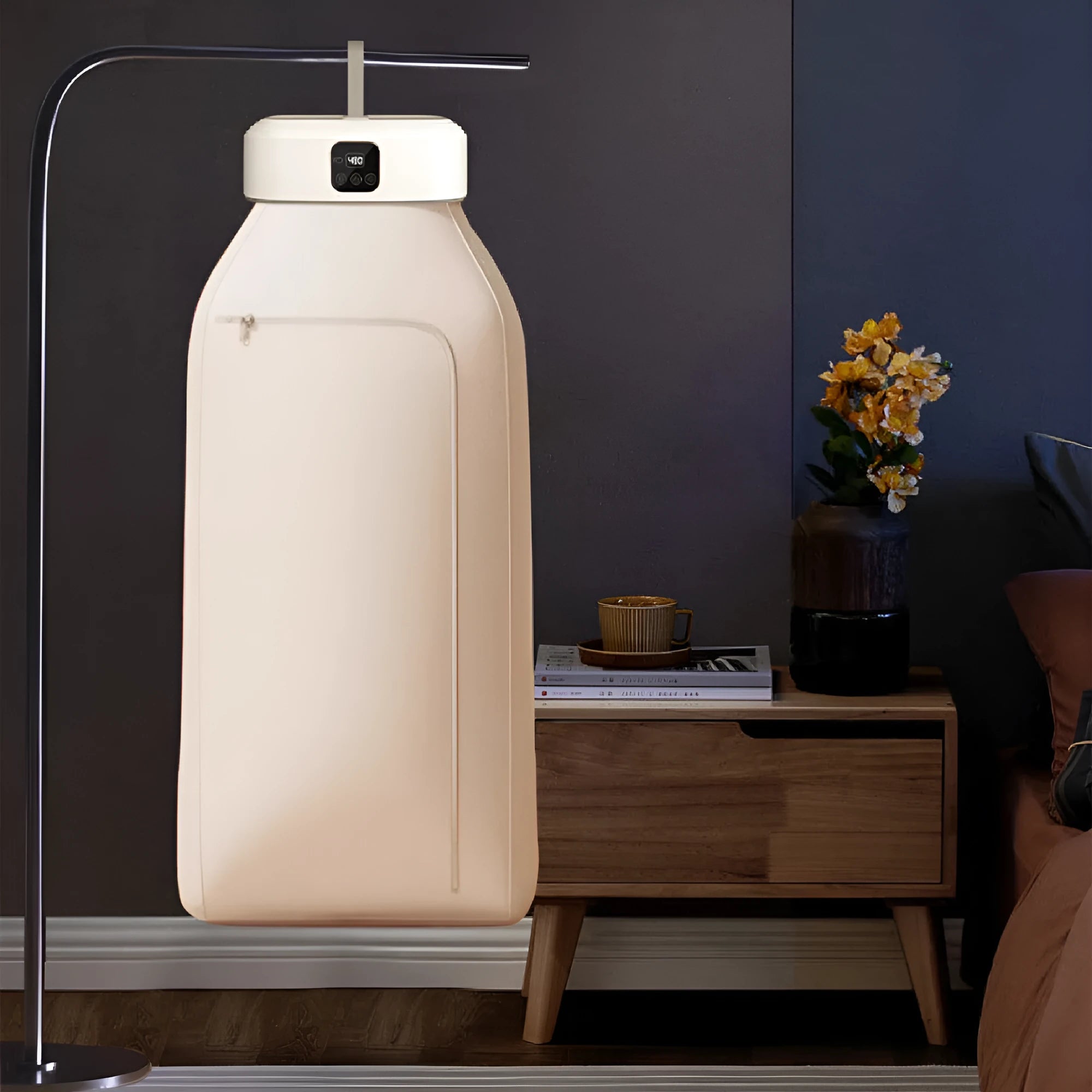 White cylindrical compact laundry dryer with remote control for small space drying