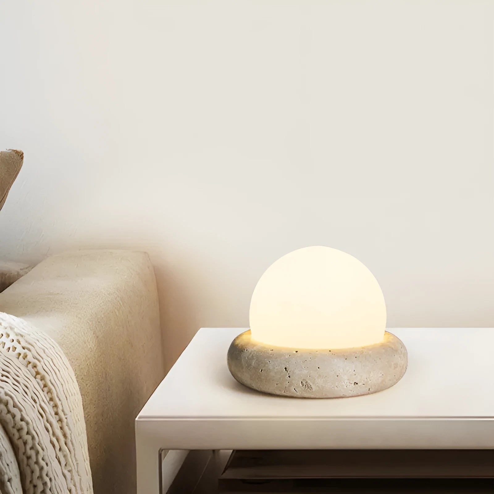 Cream modern bedside table lamp with remote control on wooden surface