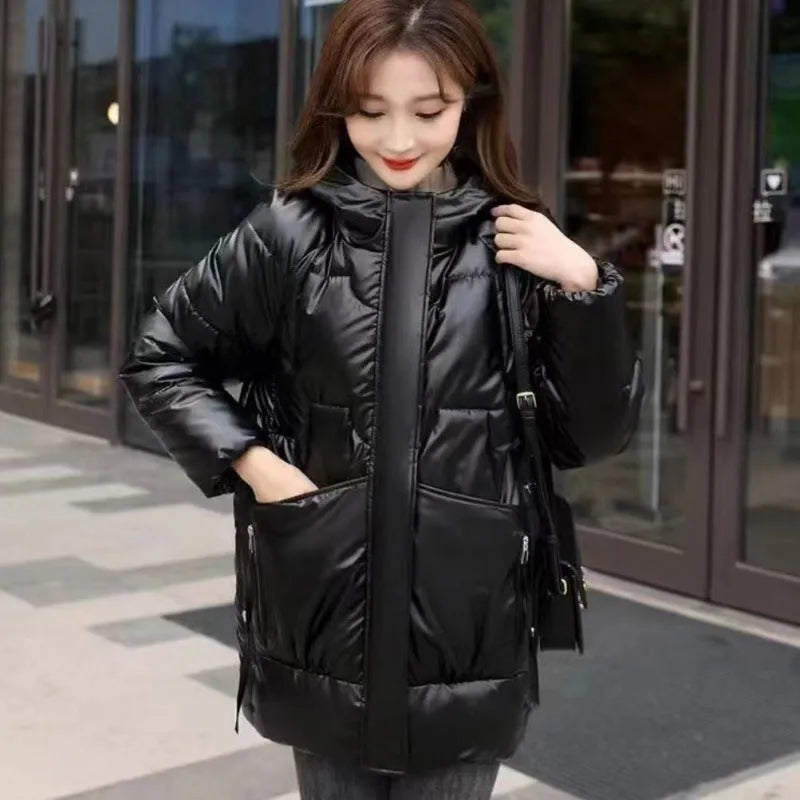 A women's loose-fit hooded winter jacket in a thick padded design, shown in one of four colour options.