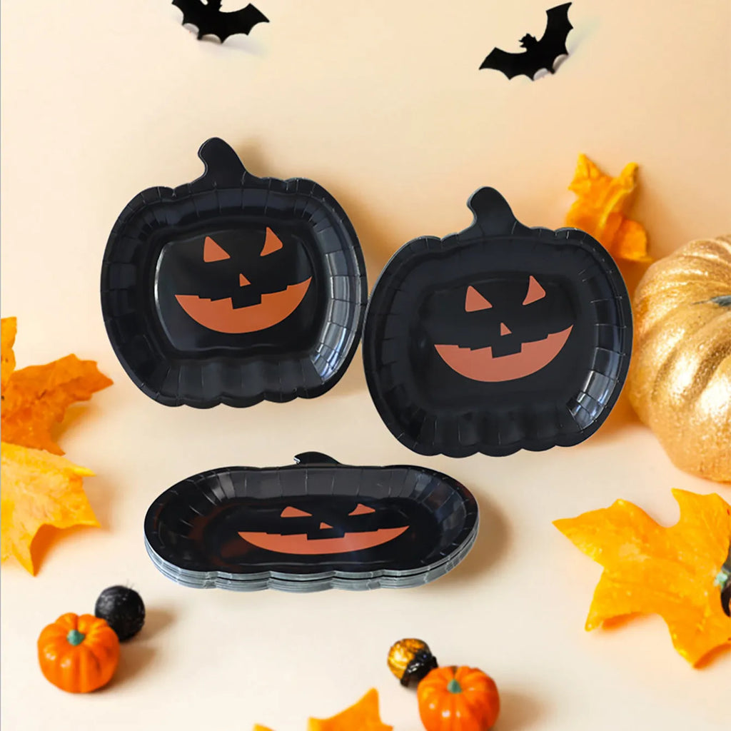 Black pumpkin-shaped disposable paper plates in 9-inch size for Halloween parties