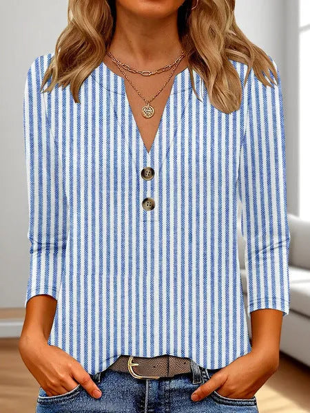 Woman wearing a loose V-neck T-shirt with a bold 3D pattern print in casual style.