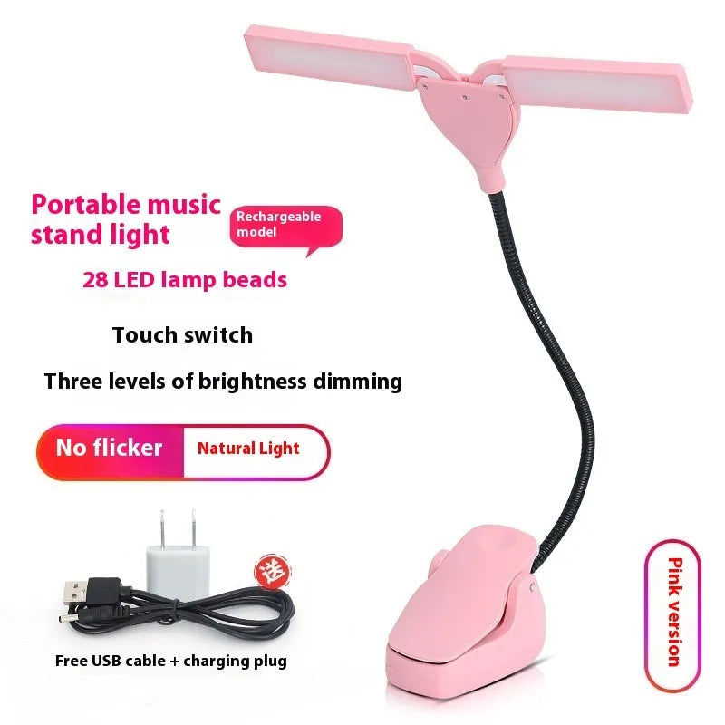 Rechargeable black music stand light with 28 lamps and USB cable on a music stand.