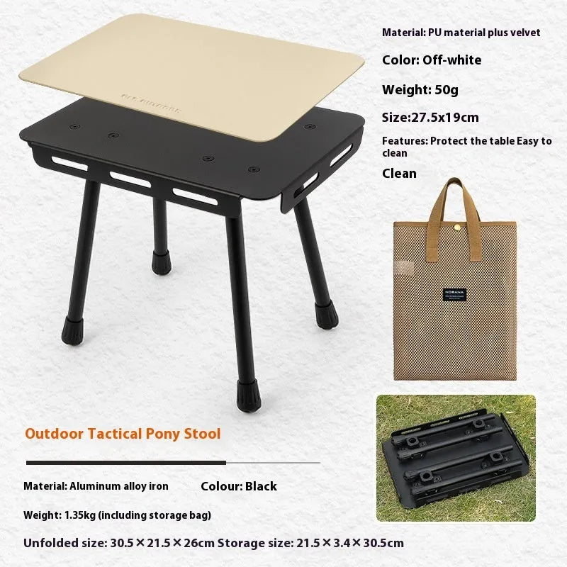 Aluminium folding camping stool that converts into a small table, shown with a tactical storage bag and a beige PU cushion.