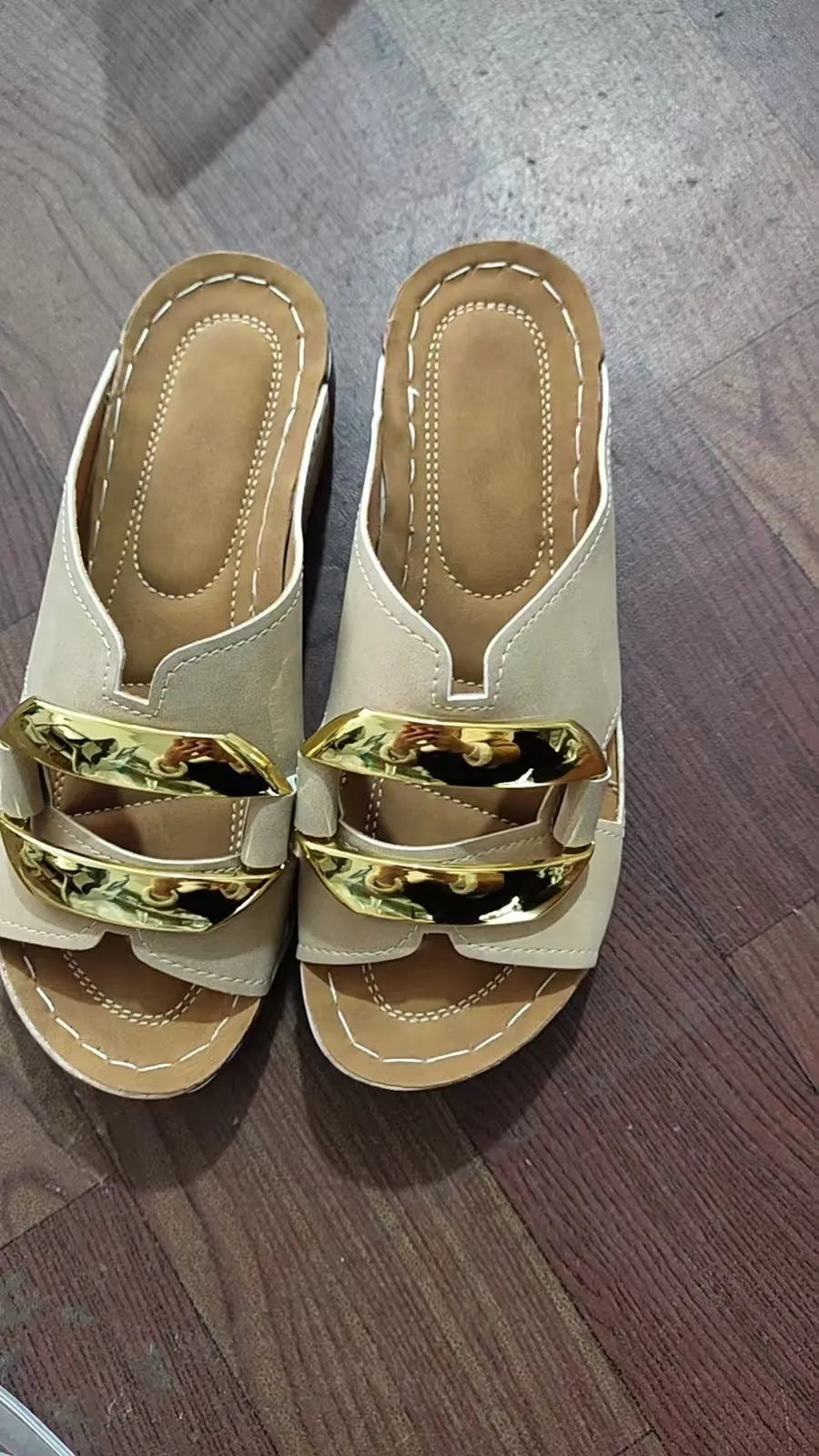 Roman-style platform flip-flops in a solid colour with a metal detail and rubber sole.