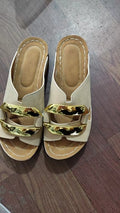 Roman-style platform flip-flops in a solid colour with a metal detail and rubber sole.