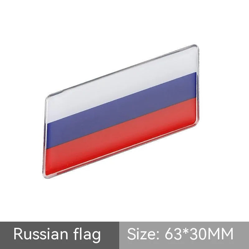 Aluminium metal car sticker with national flag design in a parallelogram shape.