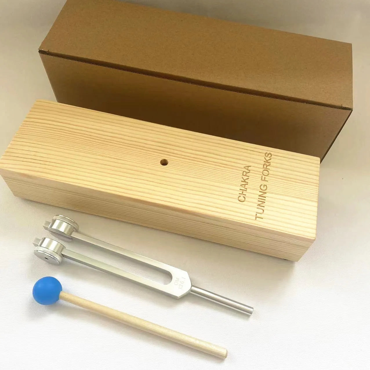 Aluminium alloy 432Hz tuning fork with integrated speaker in kraft paper packaging