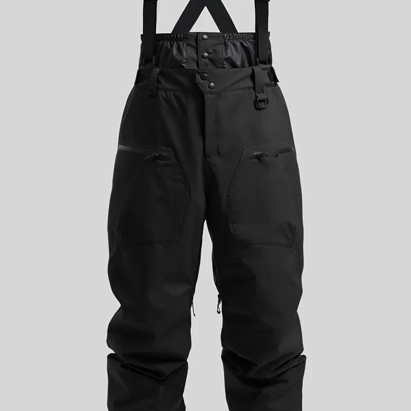 Man wearing black waterproof ski trousers with an adjustable strap on a snowy slope.