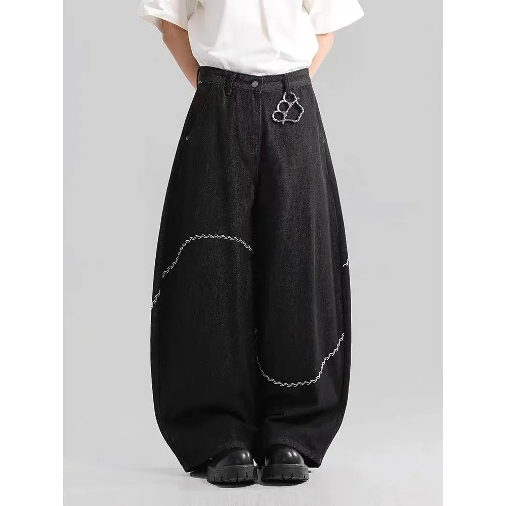 Black straight-leg denim trousers on a hanger, showing mid waist and zip placket detail.