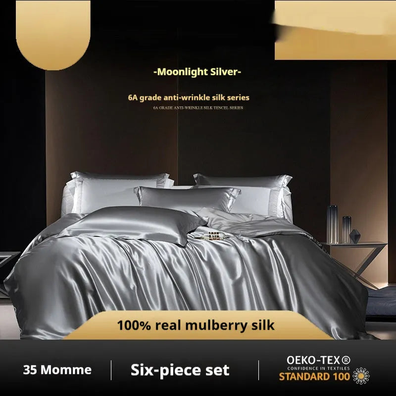 Silk four-piece quilt cover set in a solid colour displayed on a bed, showing the quilt cover and matching pillowcases.