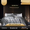 Silk four-piece quilt cover set in a solid colour displayed on a bed, showing the quilt cover and matching pillowcases.